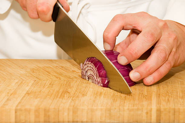 Kitchen prepared for cooking spaghetti. Onion and garlic prepared on the chopping board.Shot as Canon R5
