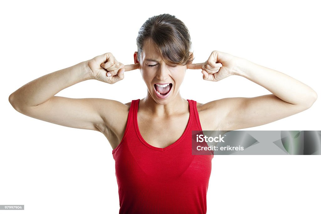 Closing the ears Portrait of disturbed young woman screaming while putting her finger on the hears 20-29 Years Stock Photo