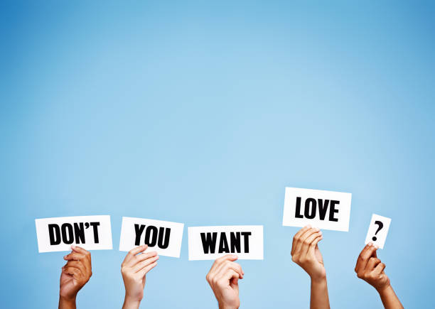 istock 'Don't you want love?' ask hand-held signs 979983046