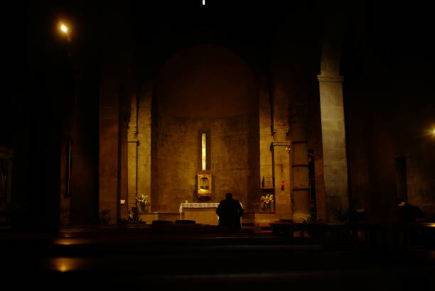 Inside of a romanian church with illuminated apse on background
