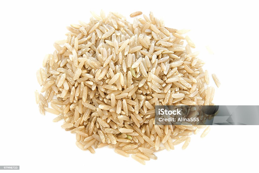 Pile of long grain brown rice on white  Brown Rice Stock Photo
