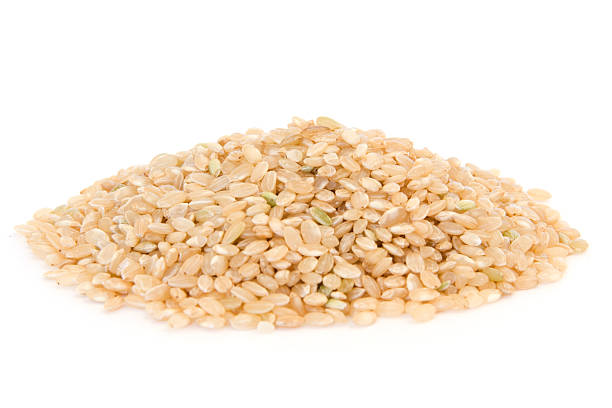 istock Pile of short grain brown rice on white 97999069