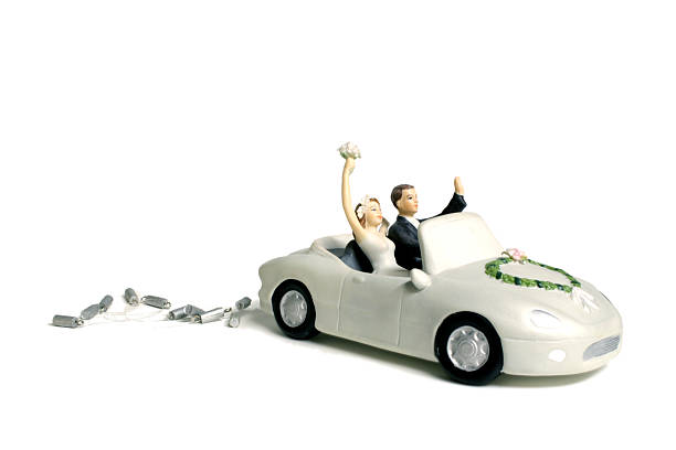 Bride and groom in a car cake topper