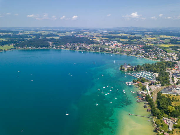 Shoreline at lake Attersee, Salzkammergut, Austria Aerial view of the shore of Schoerfling village at the northern end of famous Lake Attersee. Location: Salzkammergut, Austria. attersee stock pictures, royalty-free photos & images