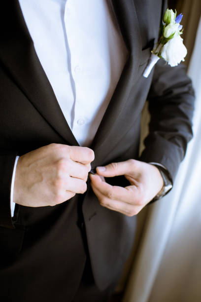 istock Groom is wearing a suit indoors 979995436