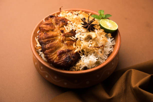 istock Authentic Fish Biryani served in a white plate over white background, selective focus 979997040