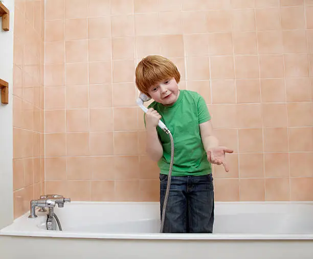 bathroom, boy, readhead, green t-shirt, shower, telephone, playing, at home