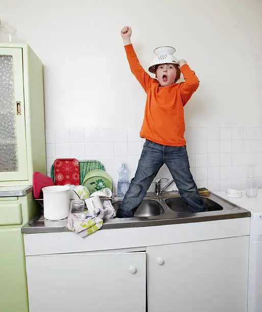 boy, kitchen, dishes, sink, colander, orange sweater, at home