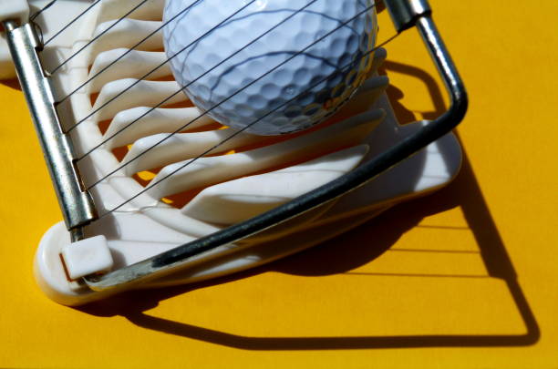 istock abstract of golf ball in egg slicer in yellow 980011002