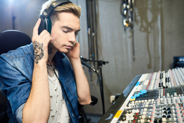 istock Focused man listening to music recording 980011440