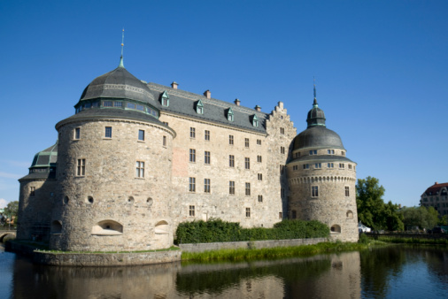 The imposing medieval Gravensteen Castle along the River Lys or Leie, in the historic old town district of Ghent, Belgium.