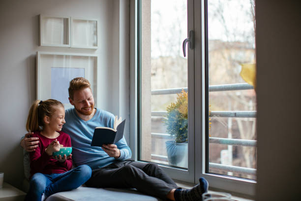 istock Father reading to his daughter 980017788