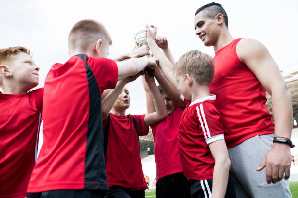istock Junior Football Team Celebrating Victory 980018048