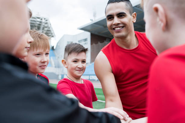 istock Junior Football Team Huddling before Match 980018238