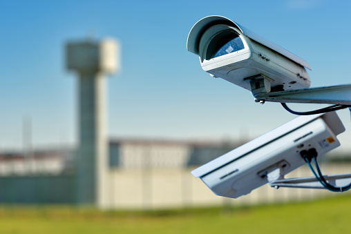 Focus on security CCTV camera or surveillance system with prison on blurry background