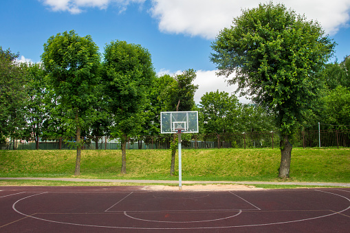 Basketball court in the outdoor schoolyard on a bright summer day