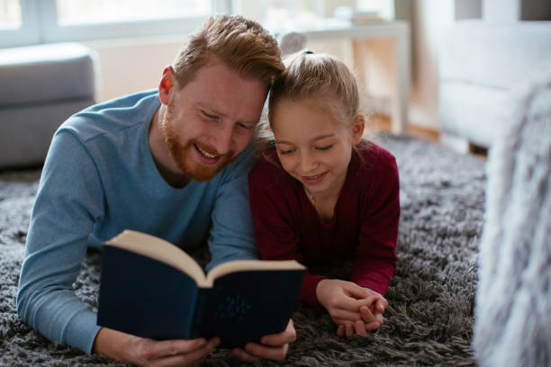 istock Father reading to his daughter 980036168