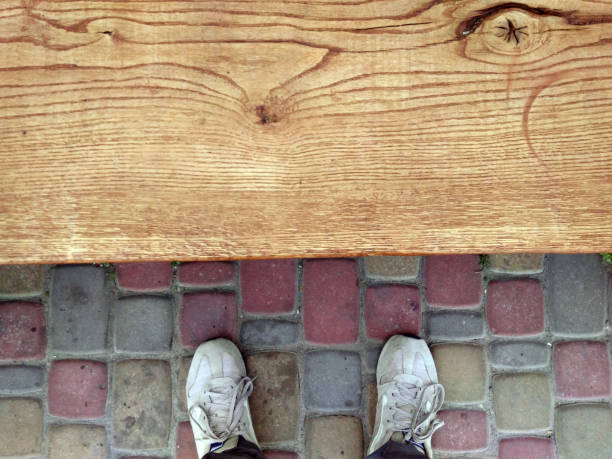 istock Feet on cobblestones. Feet near the bench. 980036200