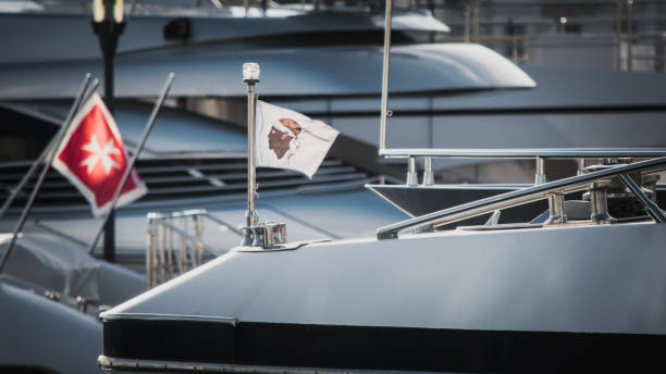 Corsica flag on a yacht Focus on Corsica flag placed on the front of a yacht at cannes, france corsican flag stock pictures, royalty-free photos & images