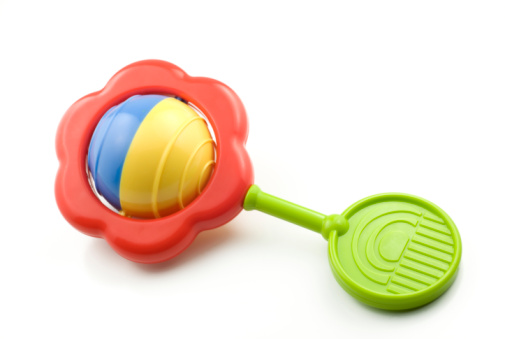 A colorful baby rattle isolated on white with copy space