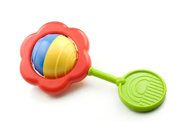 A colorful baby rattle isolated on white with copy space