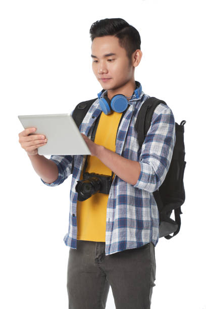 asian traveler studying map - travel ipad isolated backpack imagens e fotografias de stock