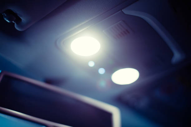 Bright dramatic car interior lights shining beams of light with rear view mirror in the background - Car concept backgrounds with selective focus copy space