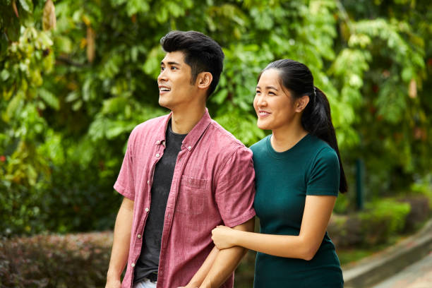 istock Loving young couple walking in park 980049670