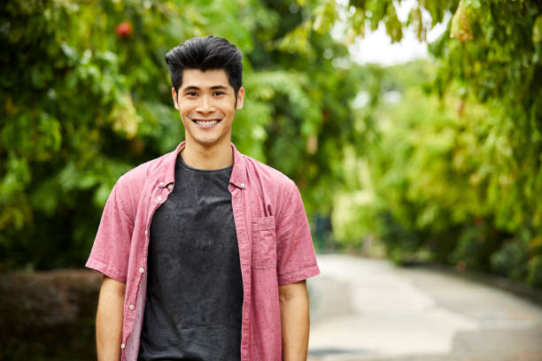 istock Portrait of handsome young man smiling in park 980049714