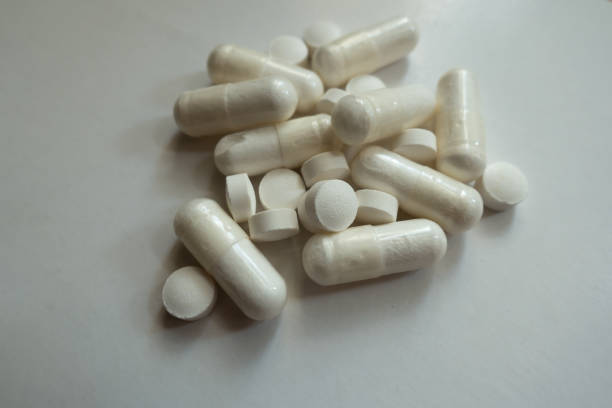 istock White magnesium citrate capsules and vitamin K2 tablets in a heap 980053832
