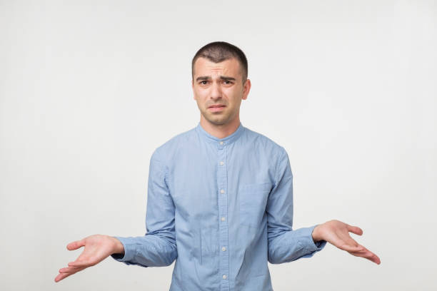 istock Caucasian man in blue shirt throws up his hands 980057338