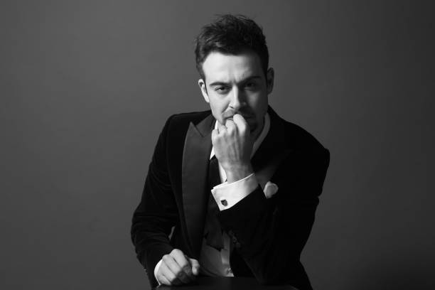 istock Young handsome man in a dinner jacket, seriously looking at the camera 980058392