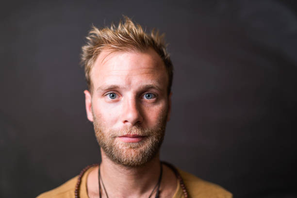 Portrait of confident man against blackboard Portrait of confident mid adult man. Close-up of handsome male is having blond hair. He is against blackboard. black guy with blonde hair stock pictures, royalty-free photos & images