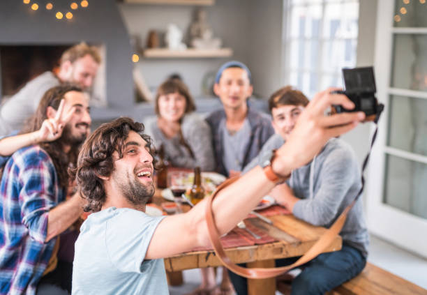 istock Happy friends taking selfie on camera at home 980068174