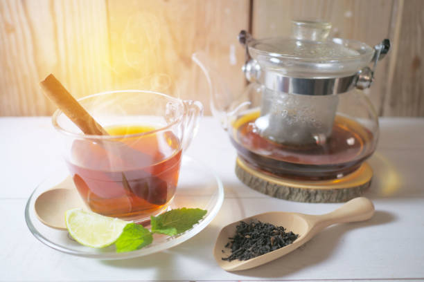 istock Tea in a glass cup, mint leaves, dried tea, sliced lime Cinnamon stick 980071558
