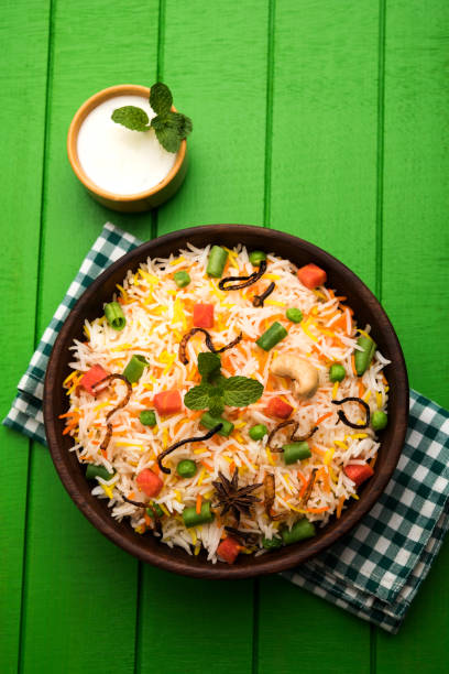 istock Indian Vegetable Pulav or Biryani made using Basmati Rice, served in a ceramic bowl. selective focus 980076038