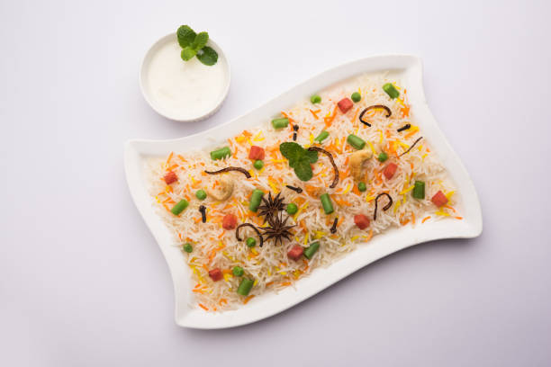 istock Indian Vegetable Pulav or Biryani made using Basmati Rice, served in a ceramic bowl. selective focus 980078342