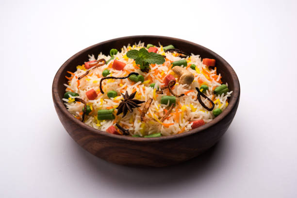 istock Indian Vegetable Pulav or Biryani made using Basmati Rice, served in a ceramic bowl. selective focus 980078526