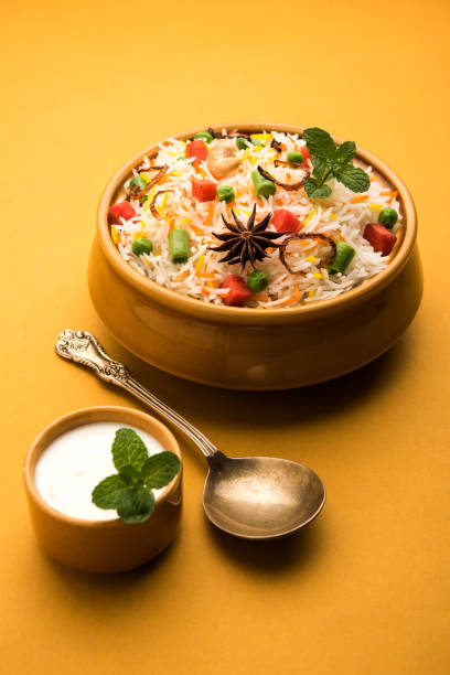 istock Indian Vegetable Pulav or Biryani made using Basmati Rice, served in a ceramic bowl. selective focus 980078604