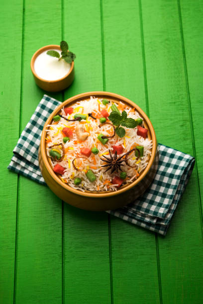 istock Indian Vegetable Pulav or Biryani made using Basmati Rice, served in a ceramic bowl. selective focus 980079060