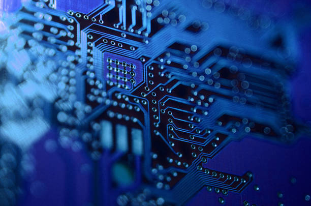 istock close-up of electronic components, electronic boards with blue light effects 980079318