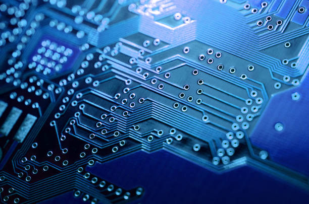 istock close-up of electronic components, electronic boards with blue light effects 980079322