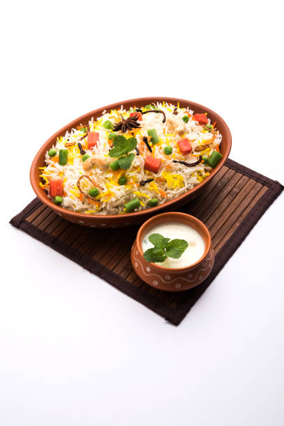 istock Indian Vegetable Pulav or Biryani made using Basmati Rice, served in a ceramic bowl. selective focus 980080428