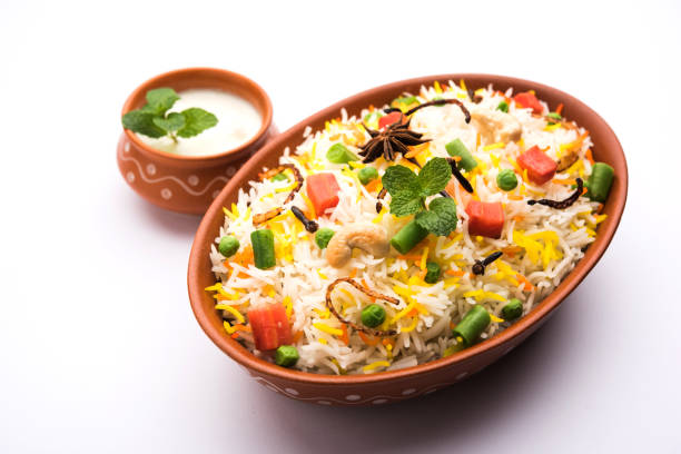 Indian Vegetable Pulav or Biryani made using Basmati Rice, served in a ceramic bowl. selective focus