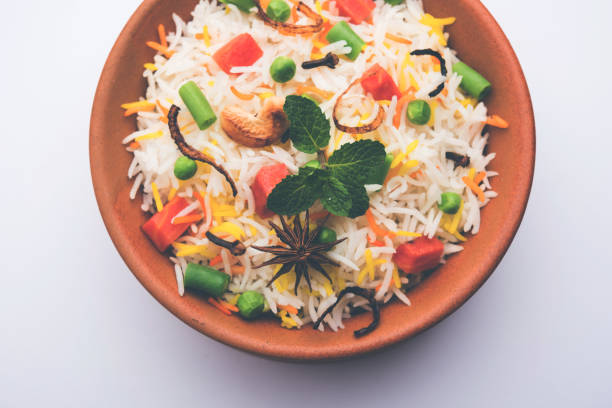 istock Indian Vegetable Pulav or Biryani made using Basmati Rice, served in a ceramic bowl. selective focus 980082522
