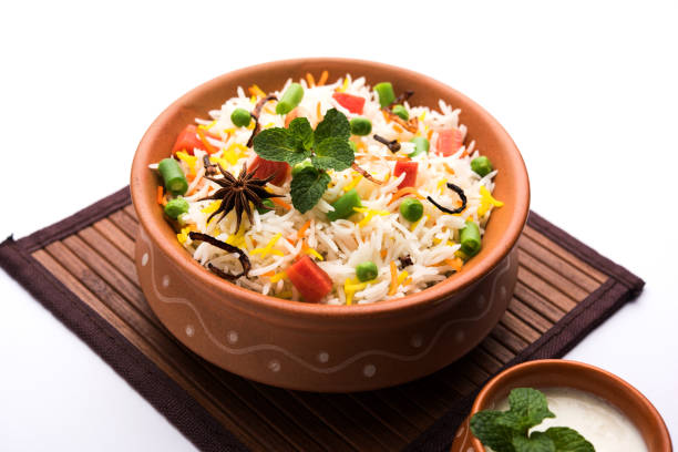 istock Indian Vegetable Pulav or Biryani made using Basmati Rice, served in a ceramic bowl. selective focus 980082554
