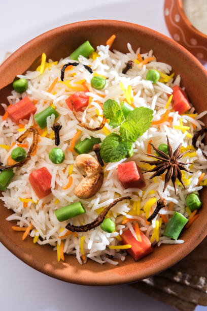 istock Indian Vegetable Pulav or Biryani made using Basmati Rice, served in a ceramic bowl. selective focus 980084642