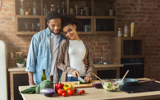 istock Loving african-american couple cooking in loft kitchen 980088324