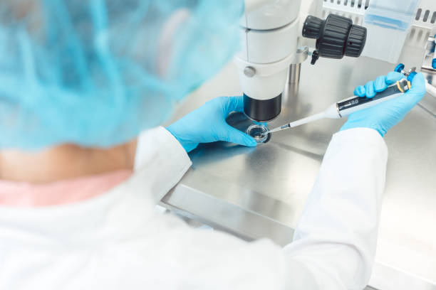 Woman scientist working with pipette in laboratory stock photo