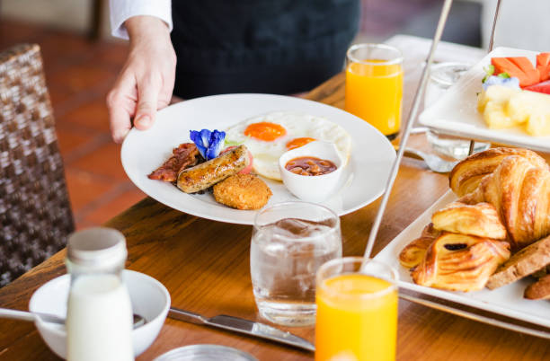 istock Hotel waitress serving food 980095276
